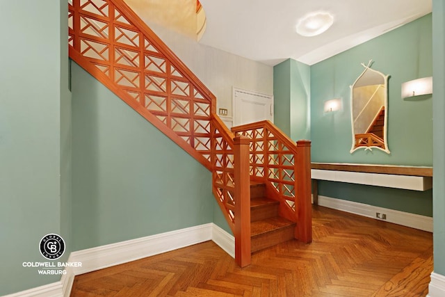 stairway featuring parquet floors