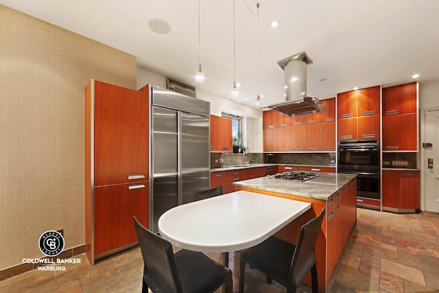 kitchen with pendant lighting, sink, appliances with stainless steel finishes, a center island, and island range hood