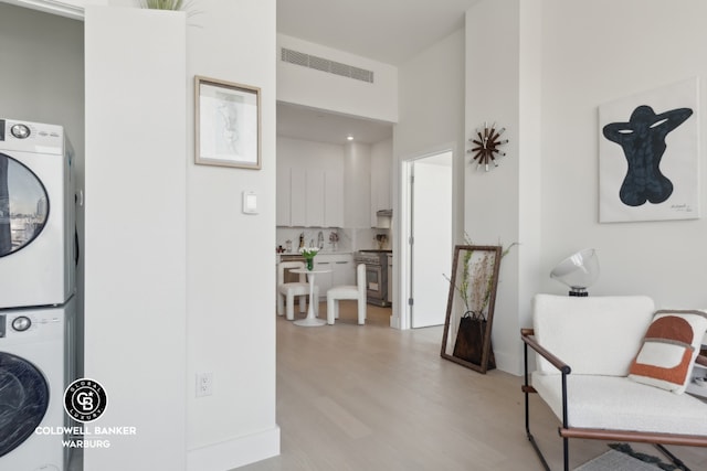 interior space featuring light hardwood / wood-style floors and stacked washer and clothes dryer