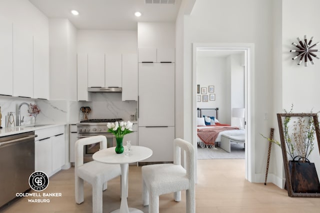 kitchen featuring stainless steel appliances, sink, and white cabinets