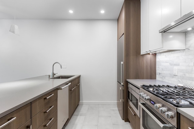 kitchen featuring exhaust hood, a sink, light countertops, white cabinetry, and stainless steel appliances