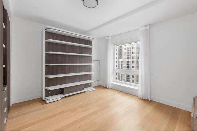 interior space with baseboards and light wood-type flooring