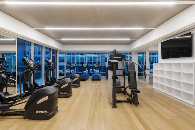 exercise room with wood finished floors