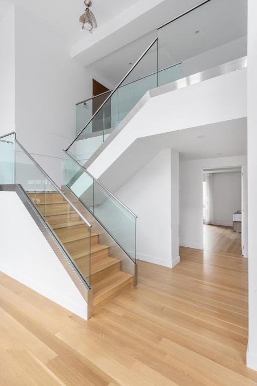 stairs featuring a high ceiling and wood-type flooring