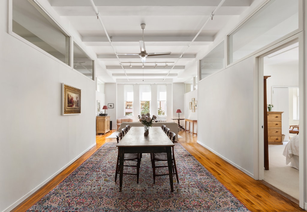 dining room featuring hardwood / wood-style floors, coffered ceiling, and beam ceiling