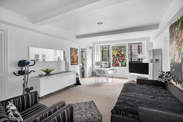 carpeted bedroom featuring beamed ceiling