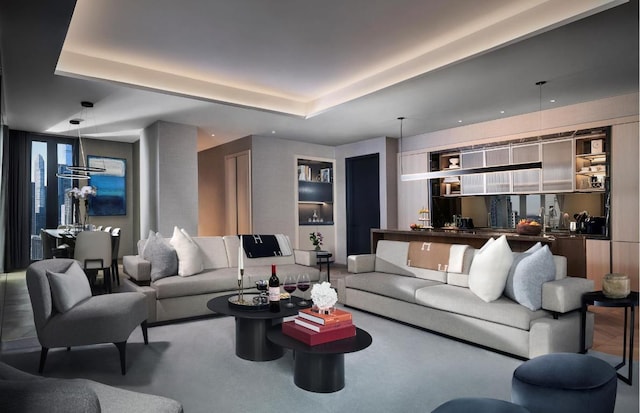 living room featuring built in shelves and a tray ceiling