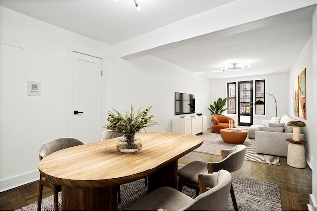 dining area featuring dark parquet floors