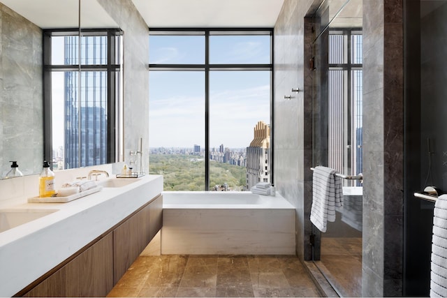 111 W 56th St Phc, Phc, New York City, NY 10019 - full bath featuring a garden tub, a sink, floor to ceiling windows, and plenty of natural light