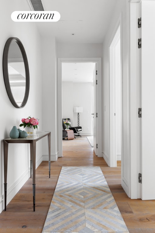 hallway with light hardwood / wood-style flooring