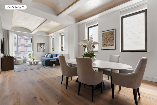 dining area featuring brick ceiling, a healthy amount of sunlight, and hardwood / wood-style flooring