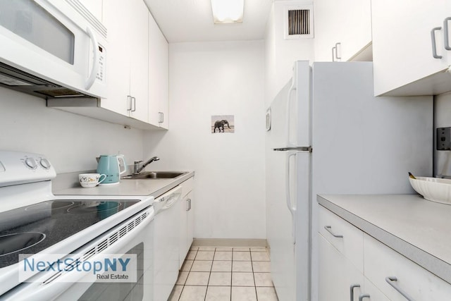 300 E 54th St Unit 6C, New York City, NY 10022 - kitchen with white appliances, a sink, light countertops, and light tile patterned floors