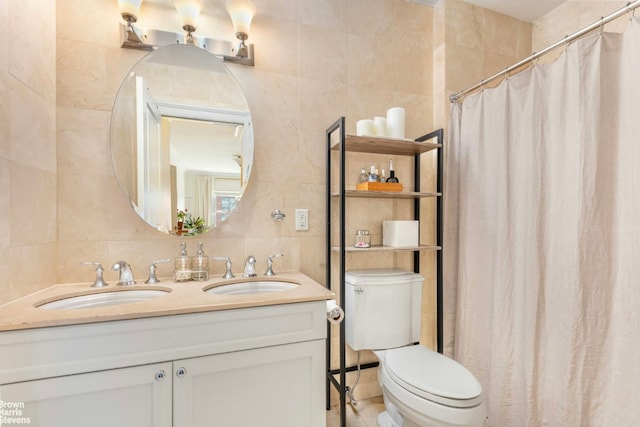 bathroom featuring tile walls, toilet, vanity, and walk in shower