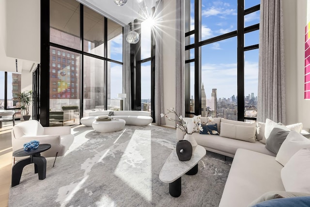 living room featuring a city view, floor to ceiling windows, and a high ceiling