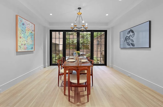 16 E 94th St, New York City, NY 10128 - dining room with baseboards, light wood-style flooring, and a notable chandelier