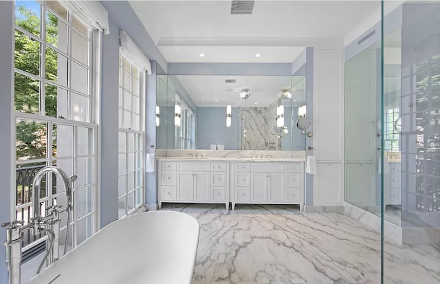 bathroom with double vanity, a stall shower, marble finish floor, a freestanding tub, and a sink