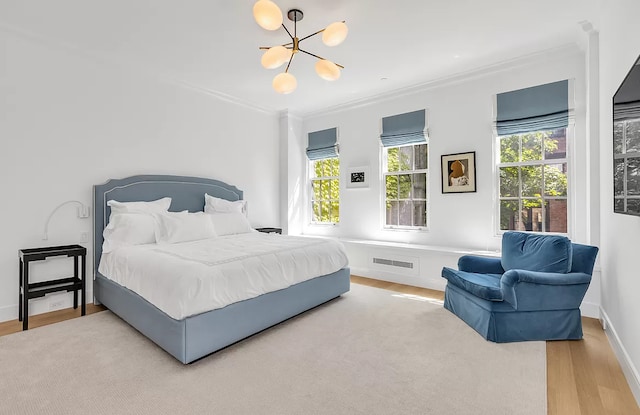 16 E 94th St, New York City, NY 10128 - bedroom featuring multiple windows, a notable chandelier, crown molding, and wood finished floors