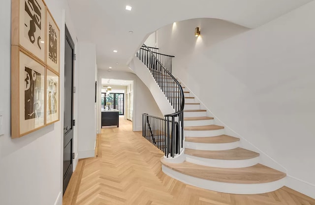 stairway featuring baseboards and recessed lighting