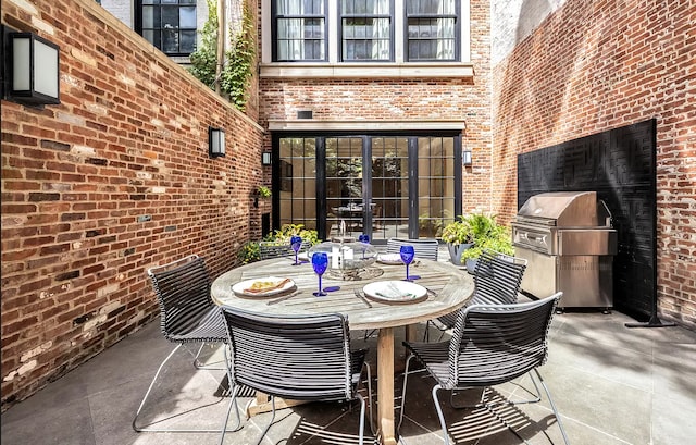 view of patio featuring outdoor dining area and grilling area