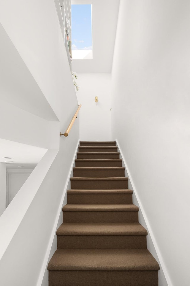 staircase featuring a towering ceiling