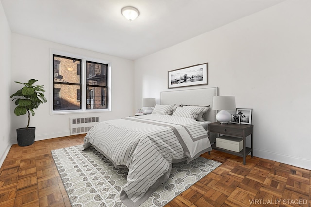 bedroom with radiator heating unit and baseboards