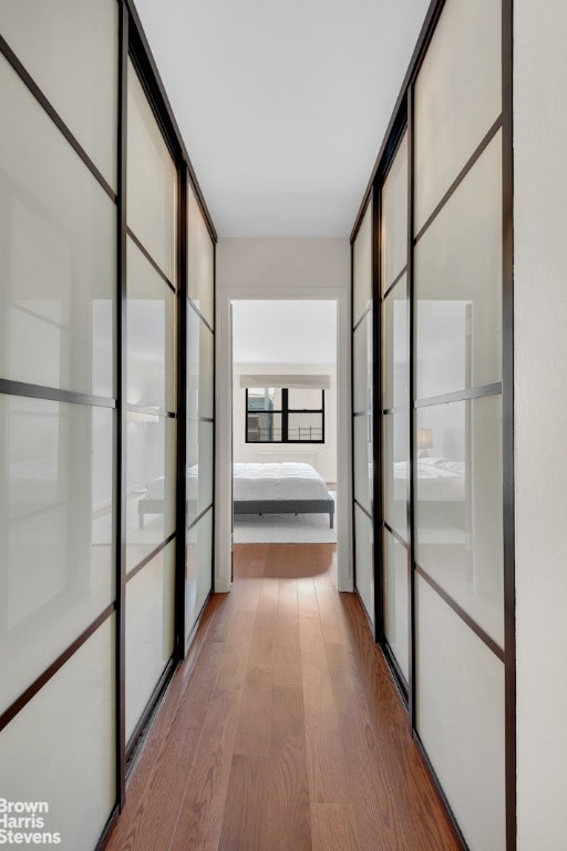 hall with light hardwood / wood-style flooring and expansive windows