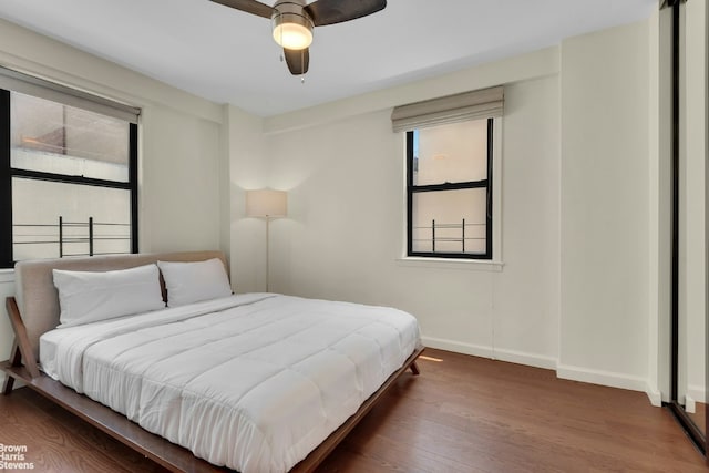 bedroom featuring ceiling fan and dark hardwood / wood-style flooring