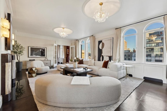 living room with crown molding and a chandelier