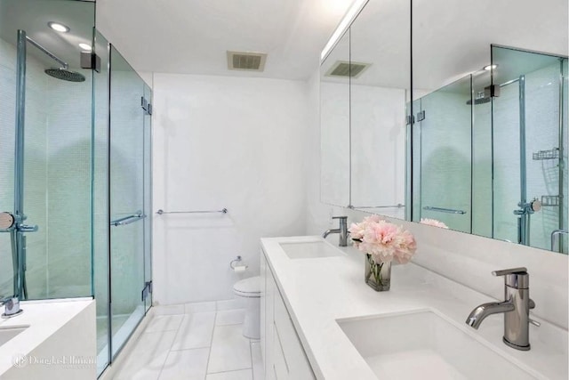 bathroom with visible vents, a stall shower, toilet, and a sink