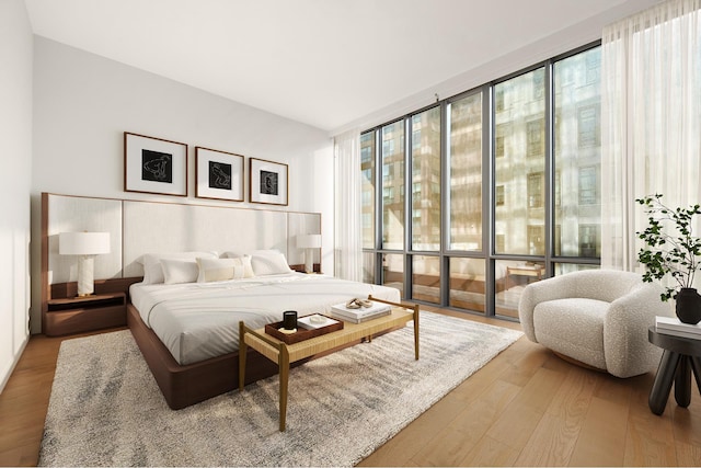 bedroom featuring wood finished floors and floor to ceiling windows