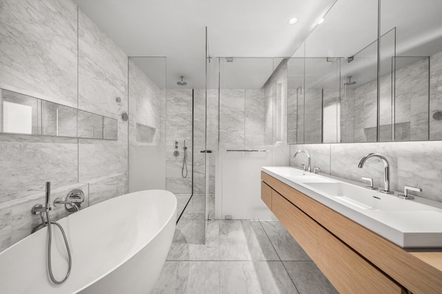 bathroom featuring a sink, tile walls, a freestanding bath, and a stall shower