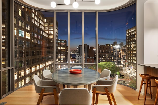 wine area featuring expansive windows and wood finished floors