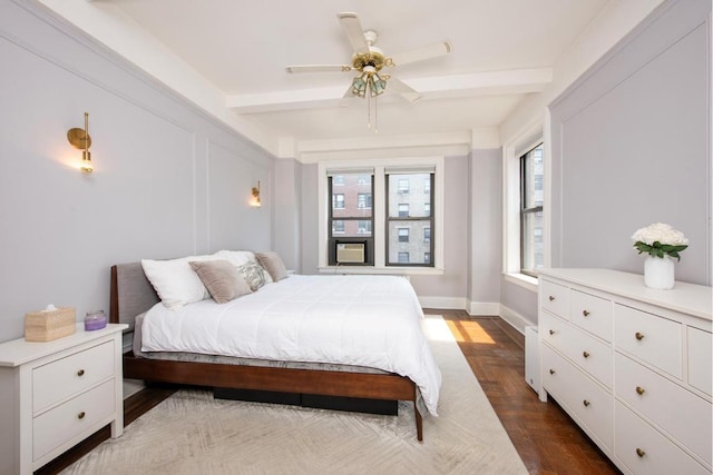 bedroom featuring ceiling fan and beamed ceiling