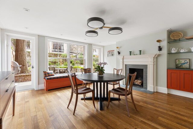 living room featuring hardwood / wood-style floors, a fireplace, and ornamental molding