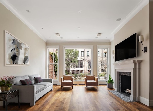 living room with hardwood / wood-style floors, ornamental molding, and a wealth of natural light