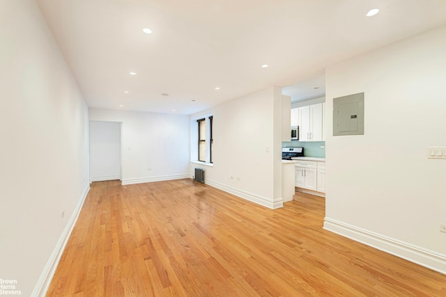 unfurnished living room with light wood-type flooring and electric panel