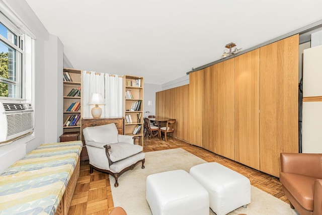 sitting room featuring light parquet flooring and cooling unit