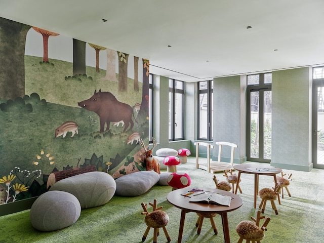 playroom featuring carpet flooring and a wall of windows