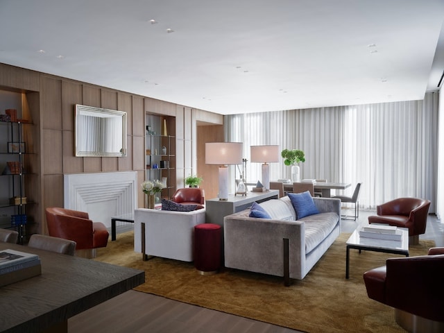 living room featuring wooden walls and dark hardwood / wood-style floors