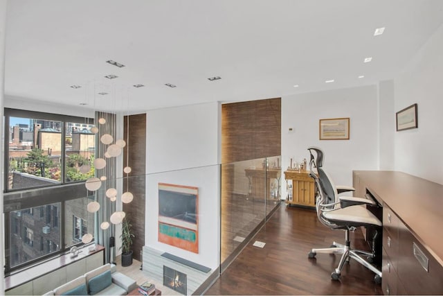 office with wood finished floors and recessed lighting