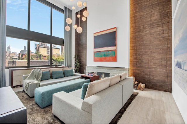 living area featuring a view of city and a high ceiling