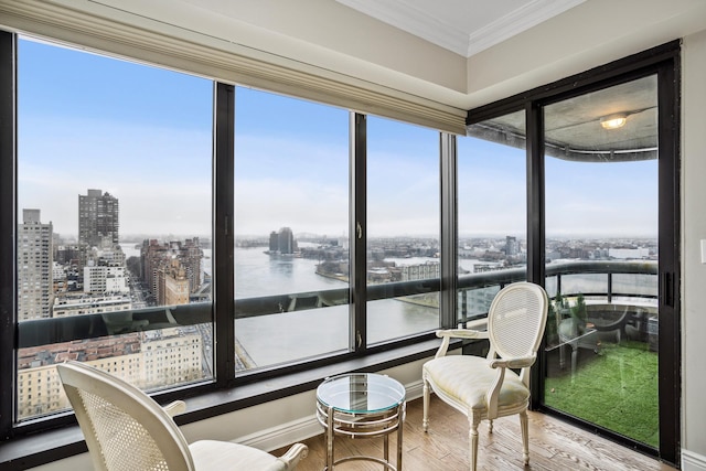 sunroom / solarium with a view of city and a water view