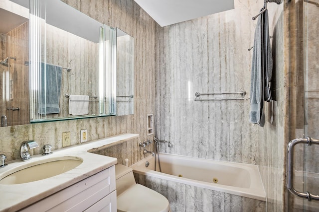 bathroom with vanity, tile walls, toilet, and a combined bath / shower with jetted tub