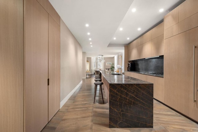 hallway featuring sink and light wood-type flooring