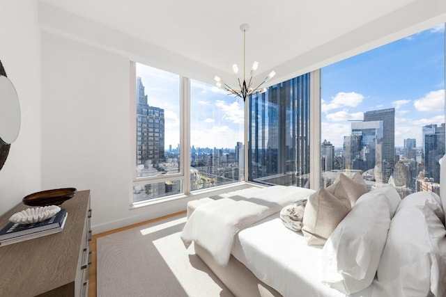 bedroom with hardwood / wood-style floors and a chandelier