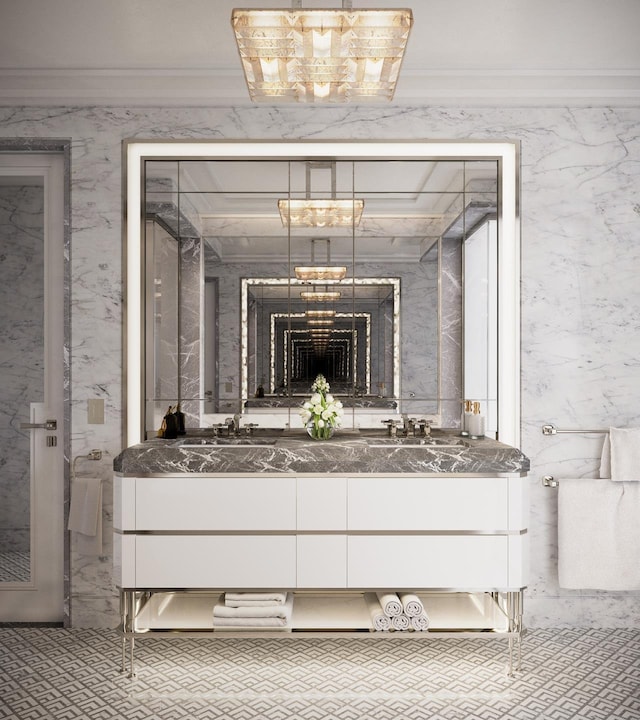 full bath featuring double vanity, a sink, and ornamental molding