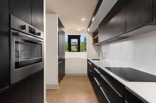 kitchen featuring baseboards, open shelves, a sink, light countertops, and black electric stovetop