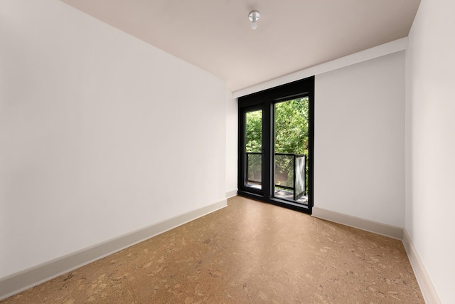 empty room featuring baseboards