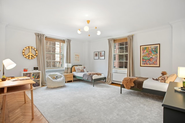 bedroom with an inviting chandelier and ornamental molding