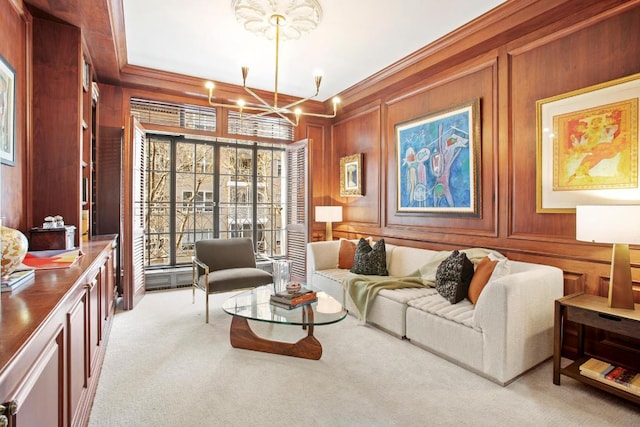 sitting room featuring ornamental molding, light carpet, a notable chandelier, and wooden walls